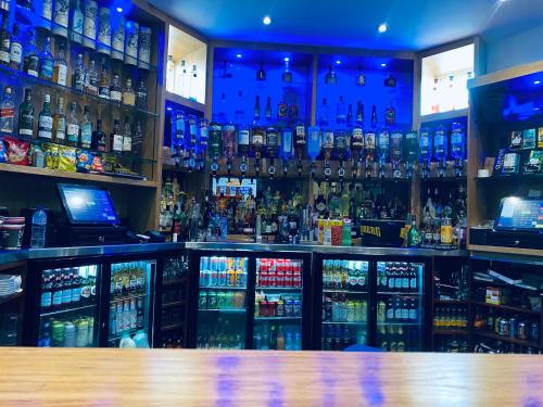 a bar filled with lots of bottles of alcohol at The Portmann Hotel in Kilmarnock