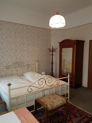a bedroom with a white bed and a mirror at Haus Häselbarth in Bad Kissingen
