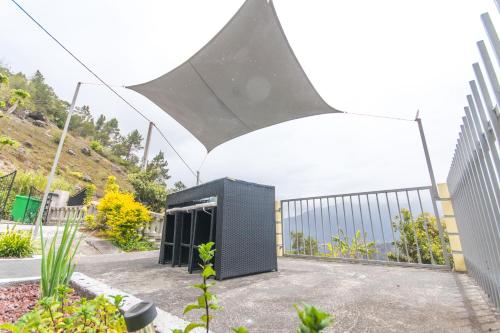 a building with a black object next to a fence at CILAOS 360° in Cilaos
