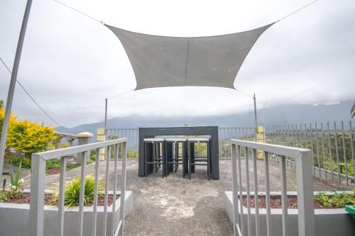 a gazebo with a fence and some plants at CILAOS 360° in Cilaos