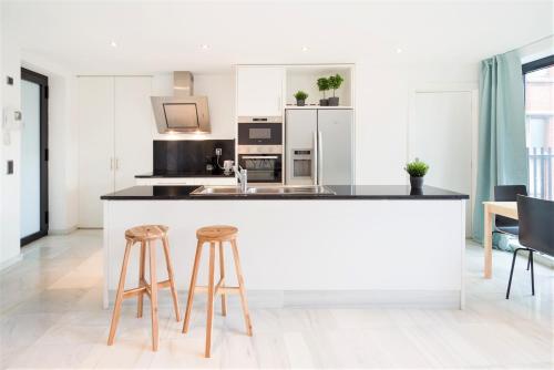 a kitchen with a counter and two stools at The Antwerp Marble Lodge in Antwerp