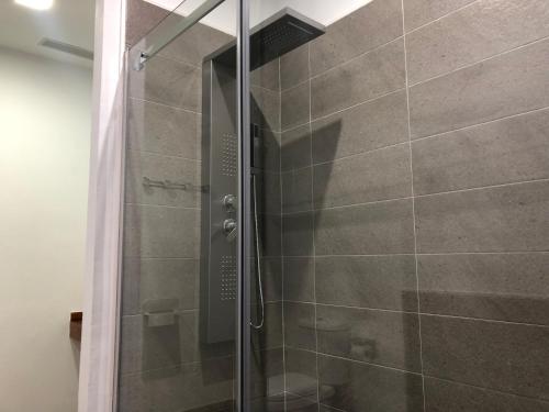 a shower with a glass door in a bathroom at La Estación in Sanlúcar de Barrameda