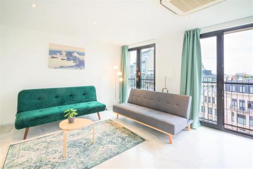 a living room with a couch and a chair at The Antwerp Marble Lodge in Antwerp
