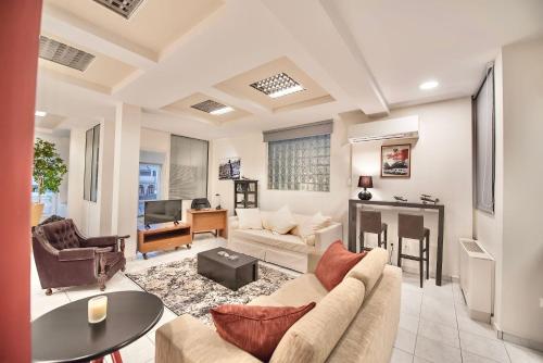 a living room with a couch and a table at #Icarus Penthouse by halu! Apartments in Thessaloniki
