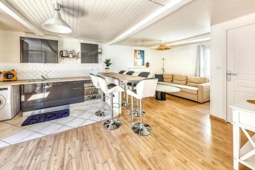 a kitchen and living room with a table and chairs at El Nido in Morlaix