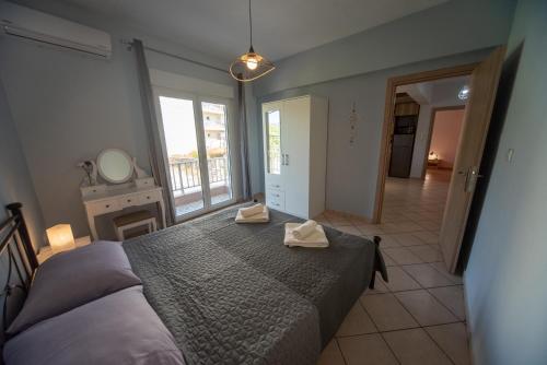a bedroom with a large bed with two towels on it at BeautyBlue in Kavala