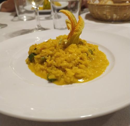 a white plate with a dish of food on a table at Torrenova di Assisi Country House in Assisi