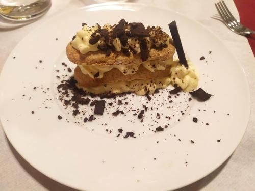 a white plate with a piece of dessert on it at Torrenova di Assisi Country House in Assisi