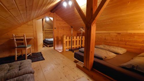 a room with a bed in a wooden cabin at ARKA in Belavići