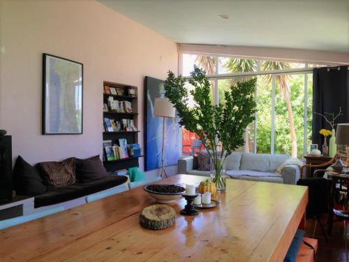 a living room with a wooden table and a couch at Verdemar in Cercal