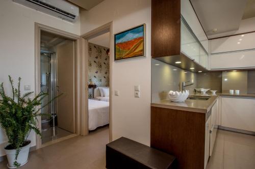 a bathroom with a sink and a room with a bed at White Crystal Beachfront Apartment in Gournes