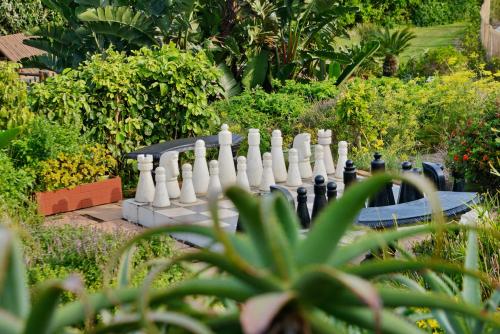 a giant chessboard in the middle of a garden at Pumula Beach Hotel in Umzumbe