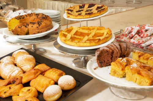 a buffet of different types of bread and pastries at Hotel Elisir in Rimini