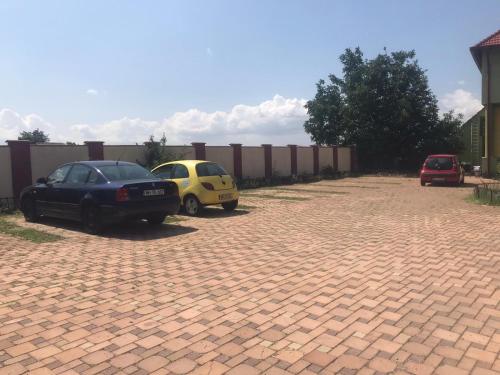 two cars parked in a brick parking lot at Hotel Eden in Şimian