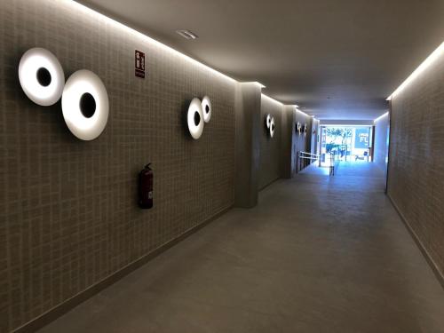 a hallway with a wall with eyeballs on it at Darya Estepona in Estepona