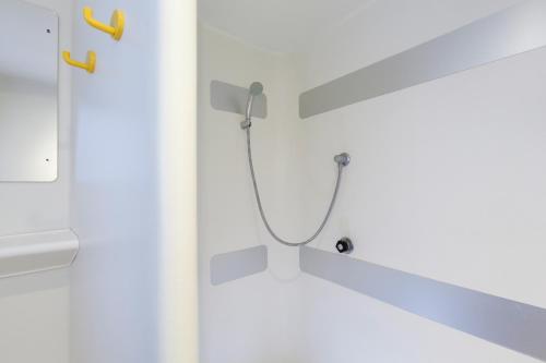 a bathroom with a shower with a shower head at hotelF1 Calais Coquelles in Coquelles