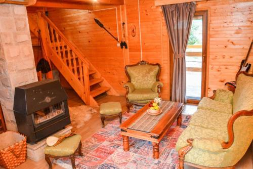a living room with a fireplace in a log cabin at Guesthouse MG in Žabljak