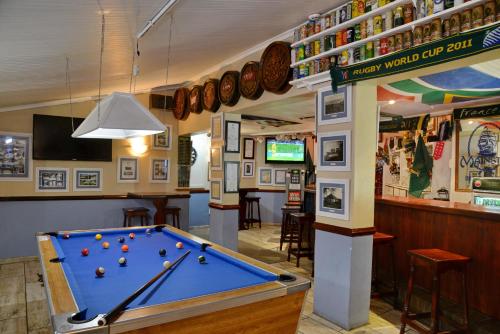 a billiard room with a pool table and a bar at Pumula Beach Hotel in Umzumbe