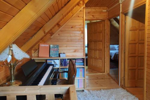 a room with a piano in a tiny house at Guesthouse MG in Žabljak