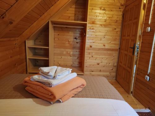 a bedroom with a bed in a wooden cabin at Guesthouse MG in Žabljak