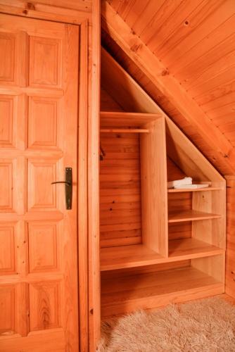 a wooden closet with a door in a attic at Guesthouse MG in Žabljak