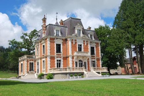 una vecchia casa di mattoni con una torre sopra di Chateau Sourliavoux, appartement en chambres d'hôtes a Vallières