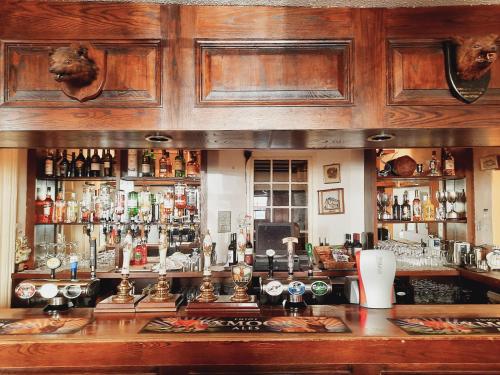 a bar with a lot of bottles of alcohol at Lion Hotel Dulverton in Dulverton
