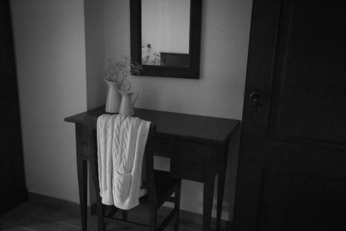 a table in a room with a mirror and vases on it at La Poiana in Barrea