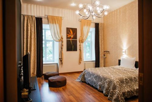 a bedroom with a bed and a chandelier at D31 Hotel in Odesa