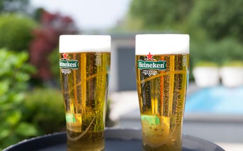 two glasses of beer sitting on a table at Novotel Rotterdam - Schiedam in Schiedam