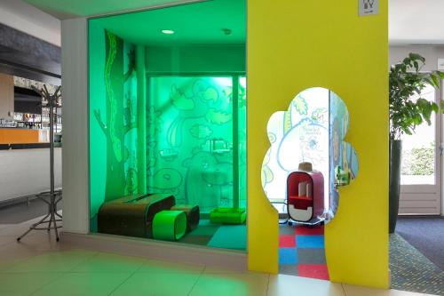 a room with a wall with a window with a skateboard at Novotel Rotterdam - Schiedam in Schiedam