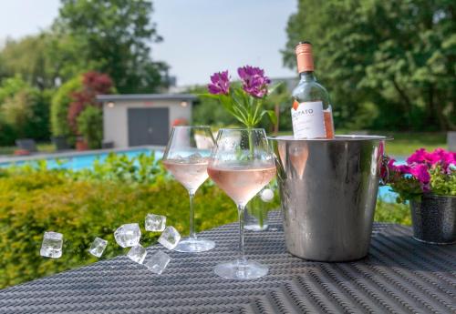 two glasses of wine sitting on a table with crystals at Novotel Rotterdam - Schiedam in Schiedam