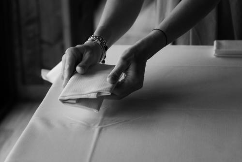 a person is folding a piece of paper on a table at La Poiana in Barrea