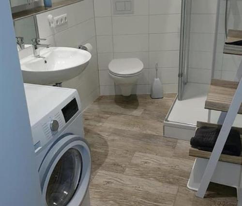 a bathroom with a washing machine and a sink at Ferienhaus Rhönblick in Bischofsheim an der Rhön