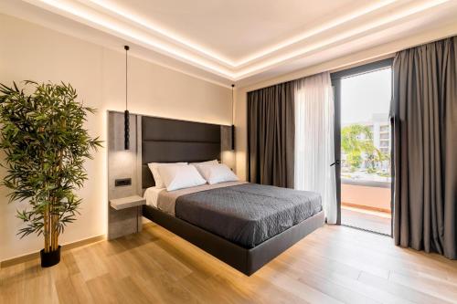 a bedroom with a bed and a large window at Megusta Suites in Theologos