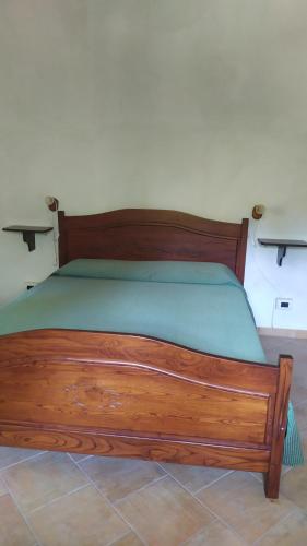 a wooden bed sitting in a room with at Fattoria Armonia in Stilo