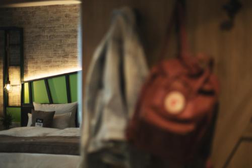 a bedroom with a bed and a red bag at Holiday Inn - the niu, Hop Forchheim by IHG in Forchheim