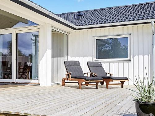 two lounge chairs sitting on a wooden deck at 6 person holiday home in Slagelse in Slagelse