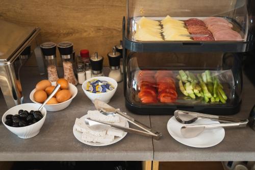 a counter topped with plates of food and other foods at Villa Pino in Velingrad