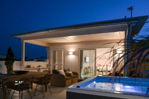 a patio with a swimming pool at night at The Well View in Preveza