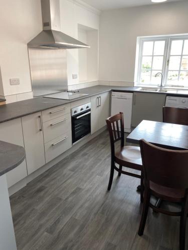 a kitchen with a table and a stove top oven at The Peel Aldergate in Tamworth
