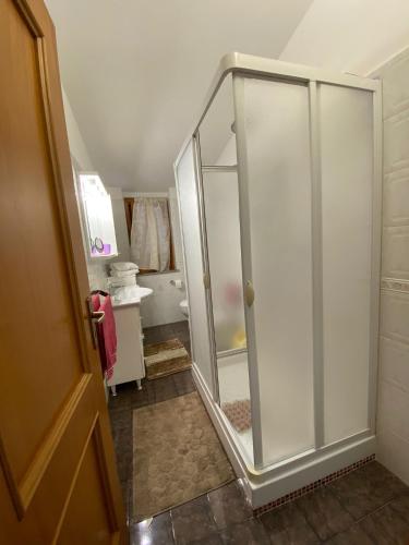 a bathroom with a shower with a glass door at A 300 passi dal mare in Tropea