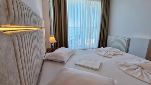 a hotel room with a bed with towels on it at Hotel Florida Mamaia in Mamaia