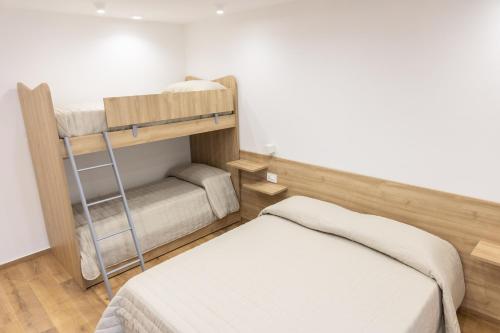 a bedroom with two bunk beds and a ladder at B&B Loricaly in Lorica