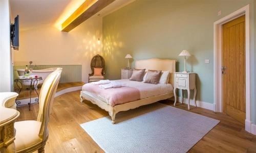 a bedroom with a large bed and a table at Twitchers Cottage in Kendal