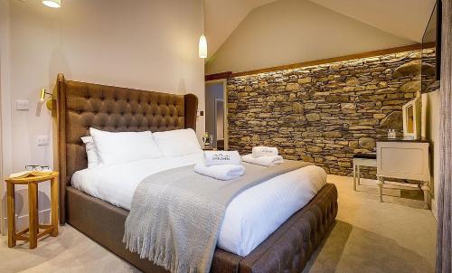 a bedroom with a large bed with towels on it at Kirkstone in Kendal