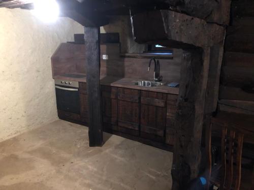 a kitchen with a sink and a stove at Etnographic Houses in Dŭlbok Dol