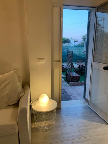 a living room with a couch and a table with a lamp at La Caletta di Afrodite in Calabernardo