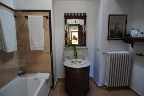 a bathroom with a sink and a bath tub and a bath tub at El Encinar de Arta in Artá