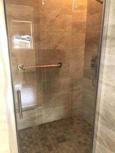 a shower with a glass door in a bathroom at Ard Cashel in Dungloe